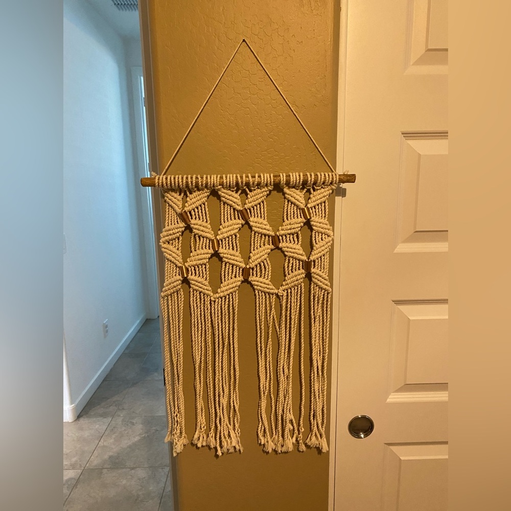 Cream macrame wall hanging with copper embellishments